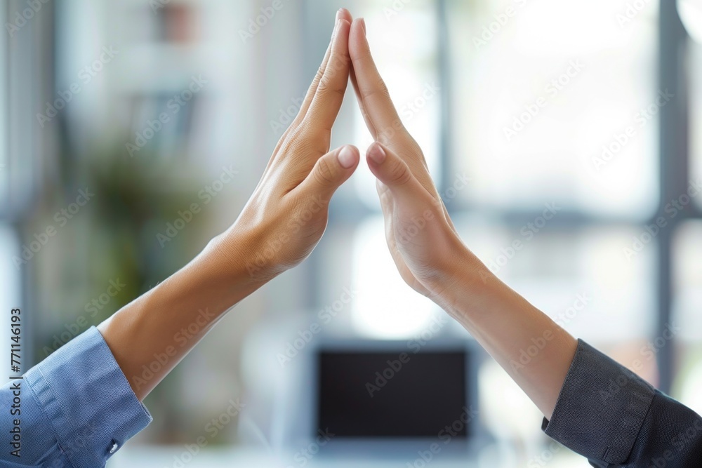 Successful business people giving each other a high five in a meeting ...