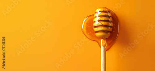 Honey dripping from a wooden stick isolated on a yellow background, Honey dripping from honey dipper isolate. Thick honey dipping from the wooden honey spoon. Healthy food and diet, bee