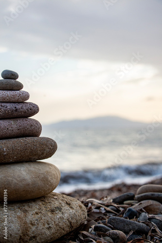 Stack of zen stones on the beach. Zen and harmony concept. Pyramid of pebbles on the beach at sunset. Stack of zen stones on the seashore. Zen concept