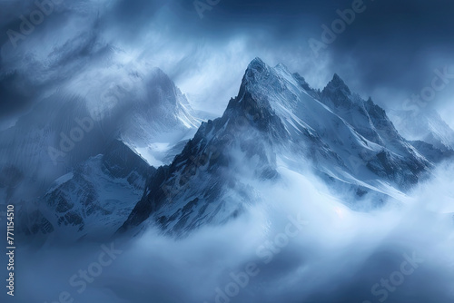 Mysterious clouds over mountains in Alaska. Snowy mountains surrounded by clouds, with dark blue and white tones, in a top view with backlighting, using high contrast with a telephoto lens.

