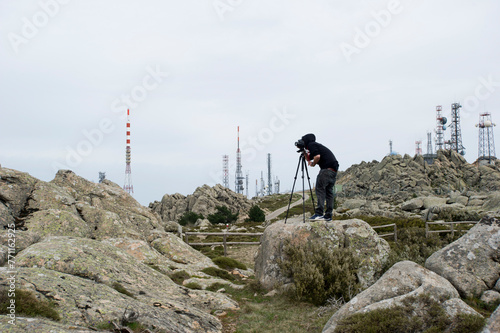 man photographing on the rocks, Mount Limbara., Tempio. Pausania, Gallura, Sardinia, Italy photo