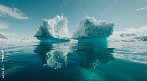 Above and below: split view of white iceberg floating in clear blue sea