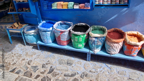 Sacks of powdered dyes on a bench in front of a shop in Chefchaouen, Morocco © Angela