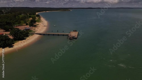 Overhead aerial clip with slow tilt down of a wharf and coastline in remote Australia. photo