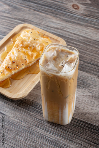 A view of a cold latte drink and a slice of sabayah. photo