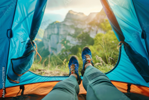 A woman stretching her feet with shoes on, against a natural backdrop. A tourist woman resting in a camping tent