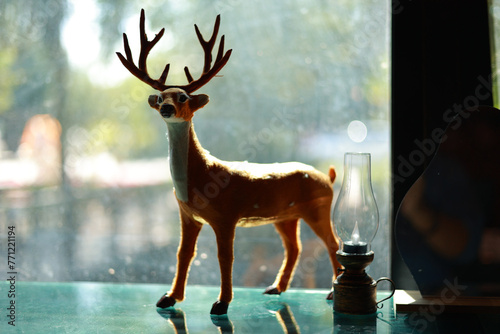 A small deer doll stood on the mirror.