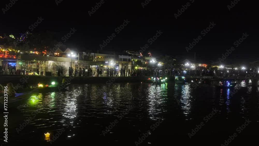 Waterfront on a river at night. Hoi An ancient town on the Thu Bon River at night. Old Town promenade. Thu Bon River. UNESCO World Heritage site. Hoi An, Vietnam. Waterfront on a river at night. Hoi An ancient town on the Thu Bon River at night. Old Town promenade. Thu Bon River. UNESCO World Heritage site. Hoi An, Vietnam.