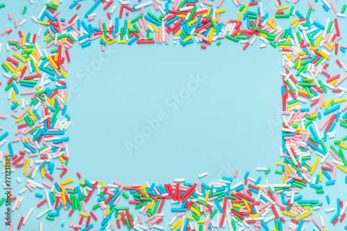 greeting wreath of colorful sprinkles on blue background, festive invitation for Valentines day, birthday, holiday and party time