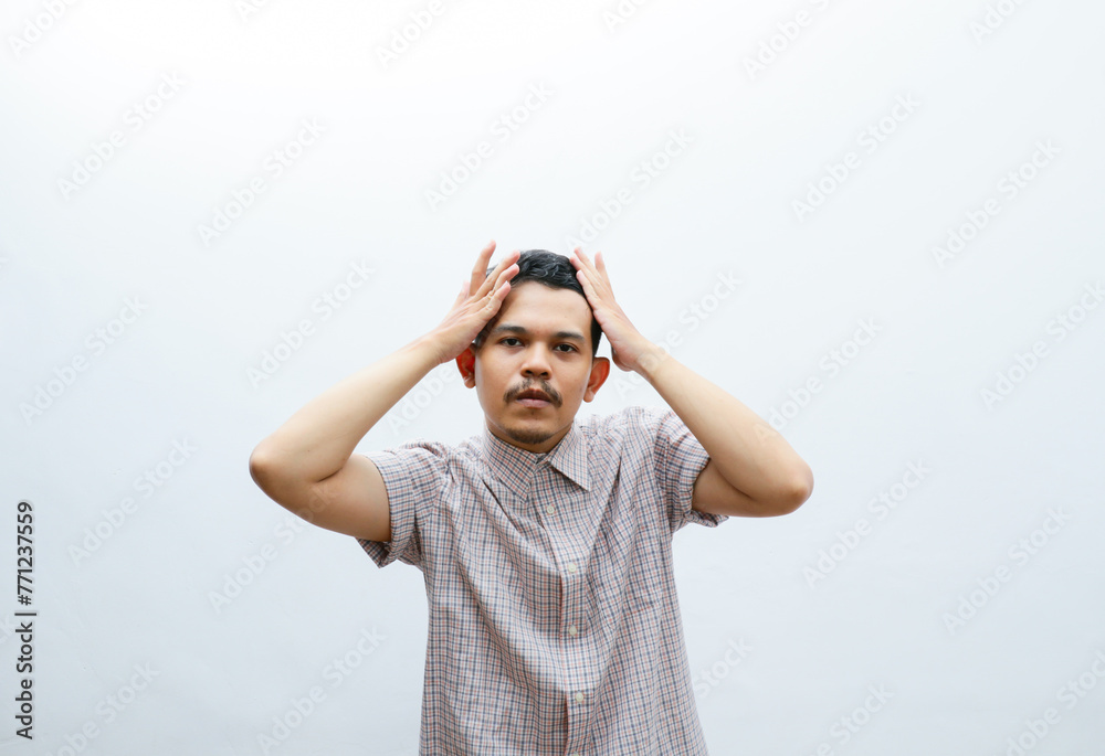 portrait of an asian young man correcting his hair style portrait of an asian young man correcting his hair style