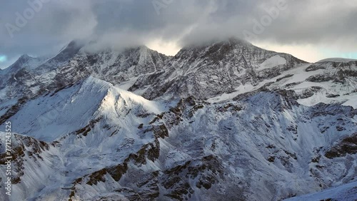 Late afternoon first fresh snowfall dusting stunning Matterhorn Zermatt Glacier peak landscape scenery aerial drone autumn Swiss Alps top of summit Gornergrat Railway Switzerland upward movement photo