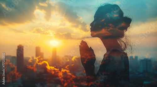Double exposure of a hand girl praying for city, Hands folded in prayer concept for faith, spirituality and religion, Church in the city with sky background. photo