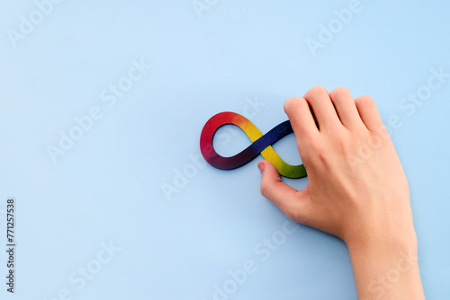 Autistic boy hands and rainbow eight infinity symbol. Autism awareness day symbol. © vetre