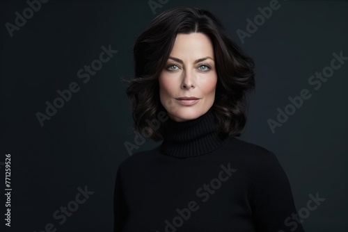 Confident middleaged woman in black turtleneck sweater.