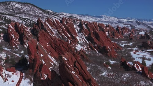 March winter morning snow stunning Roxborough State Park Littleton Colorado aerial drone over sharp jagged dramatic red rock formations Denver foothills front range landscape blue sky forward slowly photo