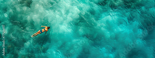 top view of a person floating around in the water in  b1e1b02f-d425-4f55-a686-430b311db16d 3 photo