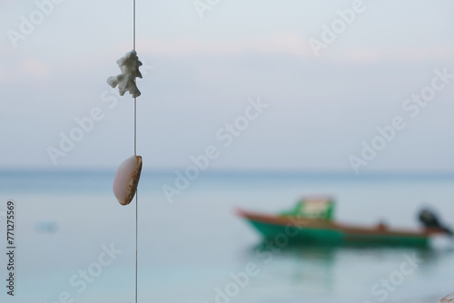 The local villager using the coral and shell as a wind chimes at Ukulhas, Maldives.