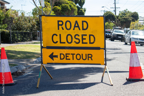 sign road closure detour and traffic cones photo