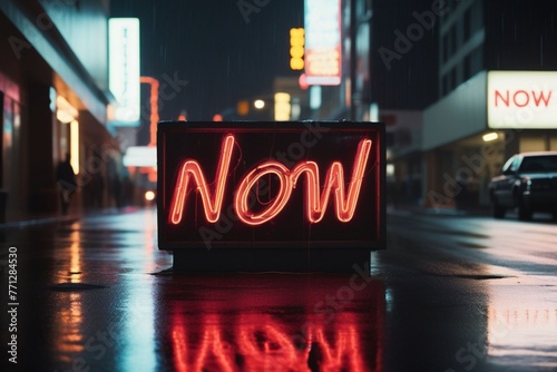 Slogan now neon light sign text effect on a rainy night street, horizontal composition