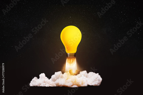 Creative light bulb rocket with blast and smoke takes off on a black background, concept. Successful launch, creative idea. Think differently. Creative generator. Smart and thinking