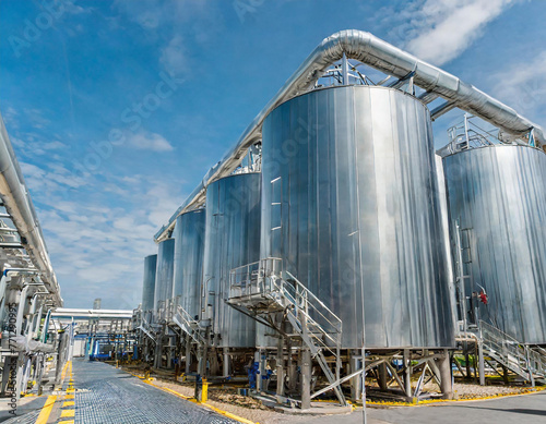 Hydrogen power plant, large steel tanks and pipes, wide angle photo. Clean H2 energy concept