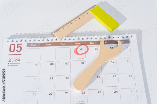05 page of 2024 calendar. The month of May 2024 with 1st May marked with red for labour day. Wooden tools and red circle 1st May illustrating world labor day. The calendar with white background. 