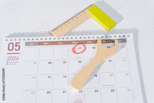 05 page of 2024 calendar. The month of May 2024 with 1st May marked with red for labour day. Wooden tools and red circle 1st May illustrating world labor day. The calendar with white background. 