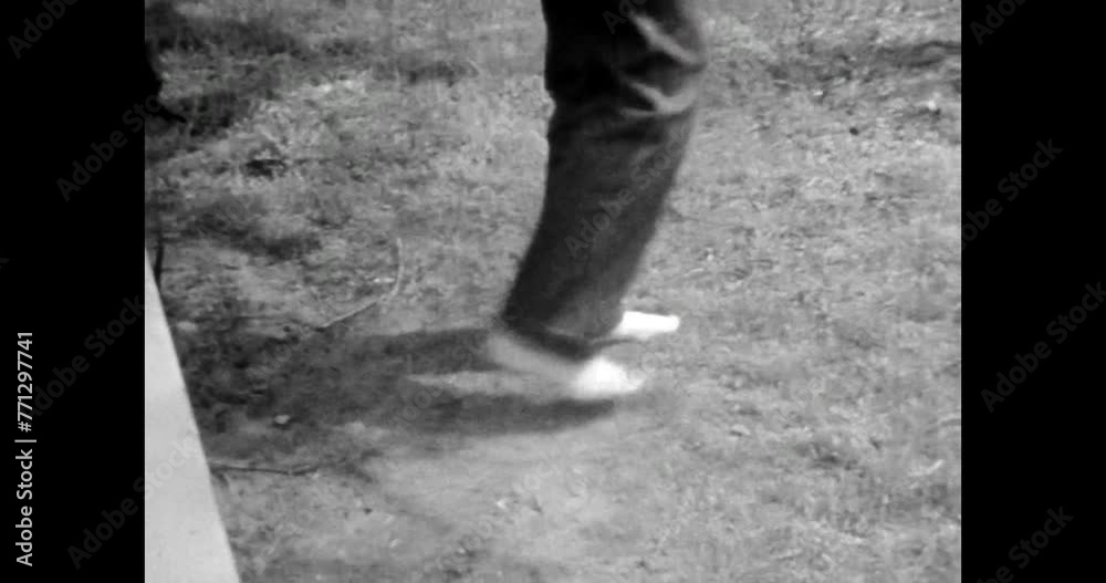 Boy taking off shoes, walking barefoot on grass. Nature unity. Young happy person relax in nature. active Carefree teenage. Archival vintage black white film. Old retro archive video. 1980s Crimea Boy taking off shoes, walking barefoot on grass. Nature unity. Young happy person relax in nature. active Carefree teenage. Archival vintage black white film. Old retro archive video. 1980s Crimea