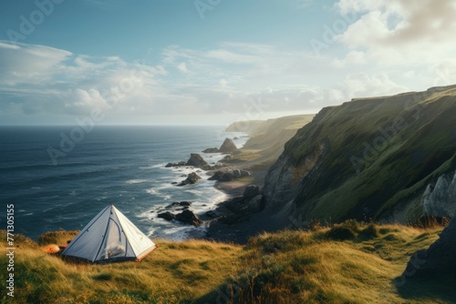 A tent pitched on a cliff overlooking the ocean.