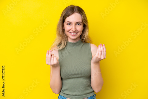 Blonde English young girl isolated on yellow background making money gesture