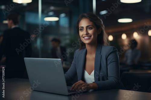 Businesswoman using laptop at desk © Michael Böhm