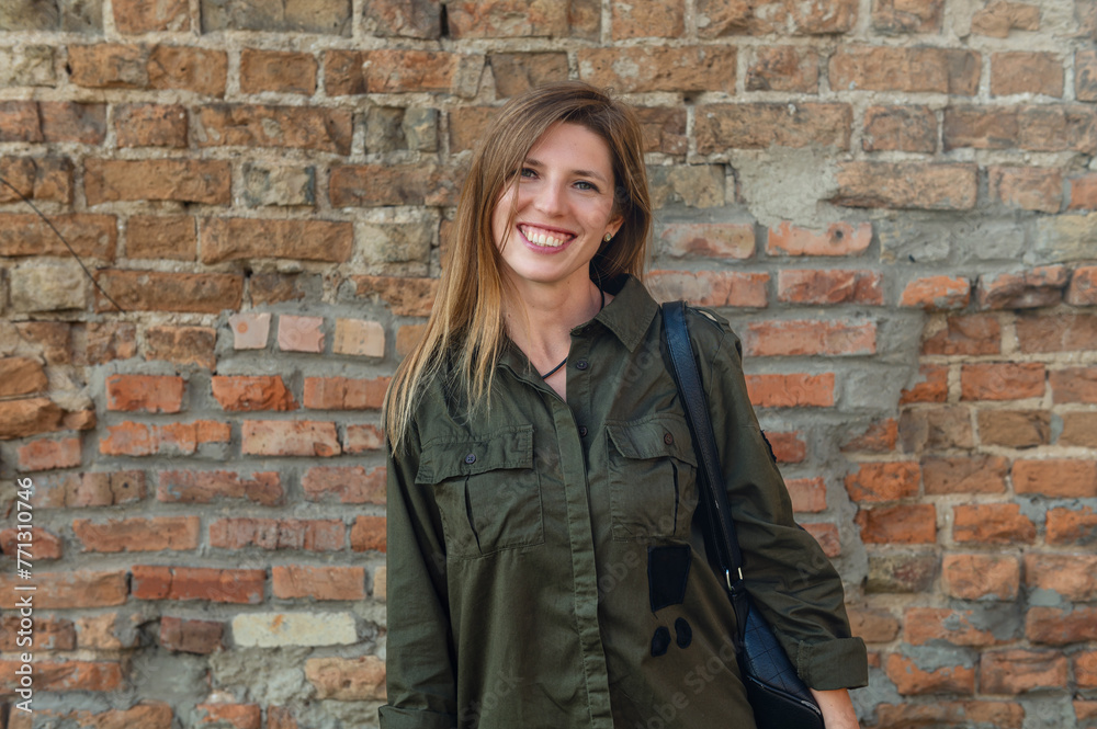 Beautiful young woman posing against stone wall of antic castle. Woman posing against the backdrop of medieval ruins Beautiful young woman posing against stone wall of antic castle. Woman posing against the backdrop of medieval ruins