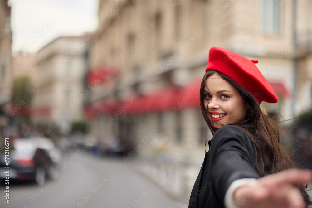 Fashion woman smile with teeth standing on the street in front of the city tourist follow me stylish clothes with red lips and red beret, travel, cinematic color, retro vintage style, urban fashion. Fashion woman smile with teeth standing on the street in front of the city tourist follow me stylish clothes with red lips and red beret, travel, cinematic color, retro vintage style, urban fashion.