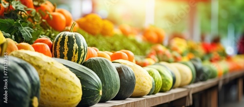 Different types of squash beautifully arranged and showcased at a vibrant market stall with other fresh produce photo