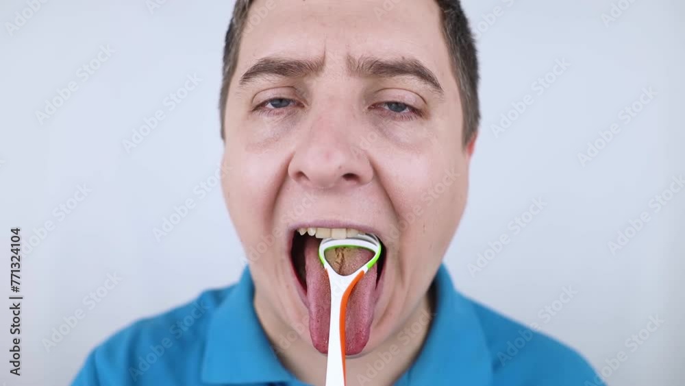 Tongue scraper. Man shows yellow plaque and then performs oral hygiene