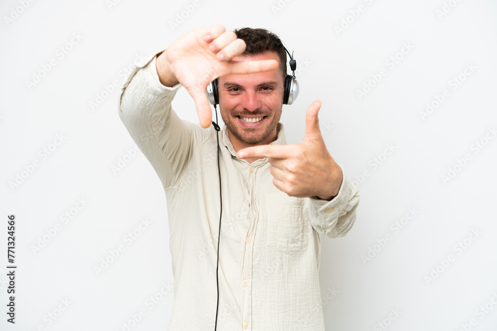 Telemarketer caucasian man working with a headset isolated on white background focusing face. Framing symbol Telemarketer caucasian man working with a headset isolated on white background focusing face. Framing symbol