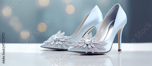 Close-up of elegant silver shoes adorned with a delicate flower on the heel and opulent wedding bridal shoes sparkling with diamonds photo