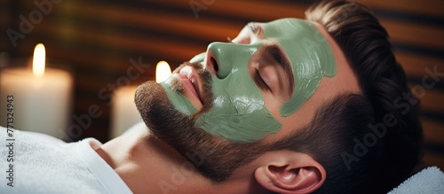 A man is seen relaxing in a spa salon while indulging in a rejuvenating facial treatment with a luxurious cucumber mask, creating a calm and peaceful ambiance