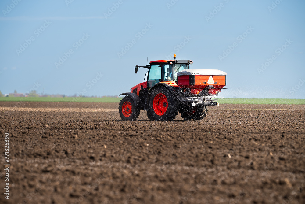 Tractor spreading artificial fertilizers Tractor spreading artificial fertilizers
