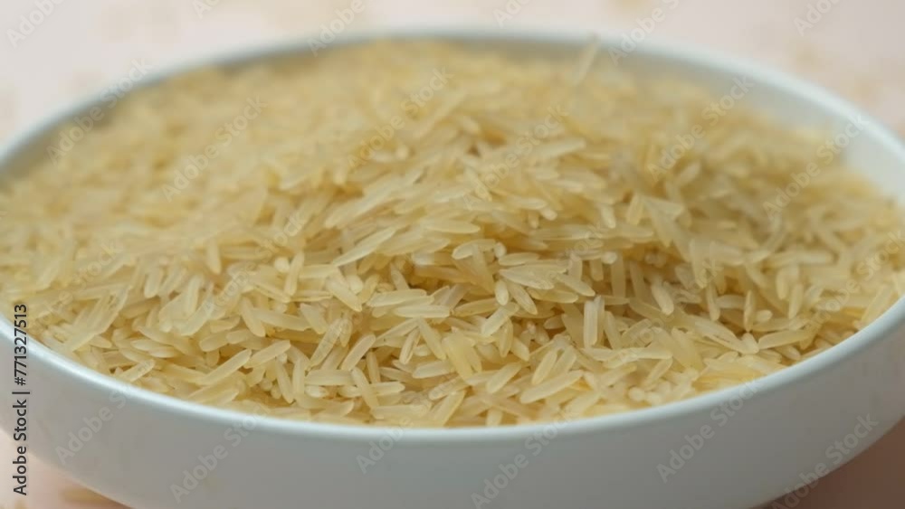 Long grain parboiled basmati rice pouring slow motion Long grain parboiled basmati rice pouring slow motion
