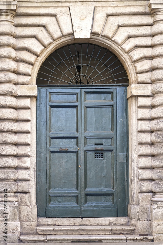doors of Rome. Classic old wooden door in a public place on a city street or in an urban environment doors of Rome. Classic old wooden door in a public place on a city street or in an urban environment