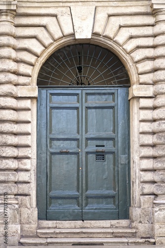 doors of Rome. Classic old wooden door in a public place on a city street or in an urban environment © Irina Ukrainets