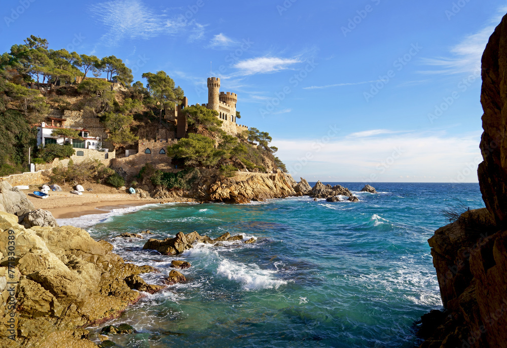 Spain. Coast of the Costa Brava. Catalonia. Lloret de Mar. Mediterranean Sea. Beautiful rocks. A sea wave hits the shore. Foam and sea spray