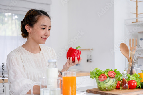 Young woman embraces joyful moments in kitchen.