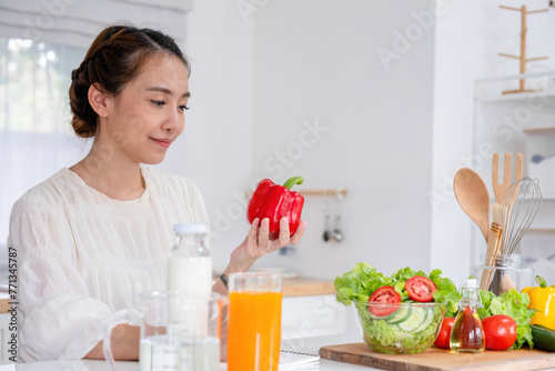Young woman embraces joyful moments in kitchen.
