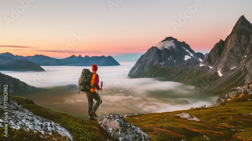 Title   The beginning of new days  Art Description  A hiker stands on the edge of Islands  at sunrise  overlooking a breathtaking vista of green valleys and distant islands shrouded in fog  under a sk