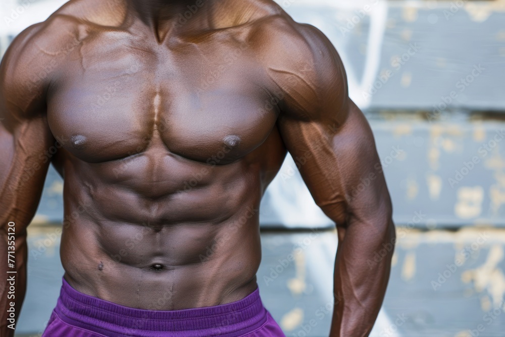 Fototapeta premium Afro American fitness model torso in purple top with well defined abdominal muscles