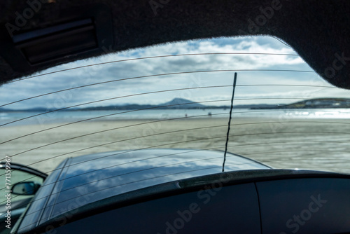 The beach in Downings seen through boot window of car, County Donegal, Ireland
