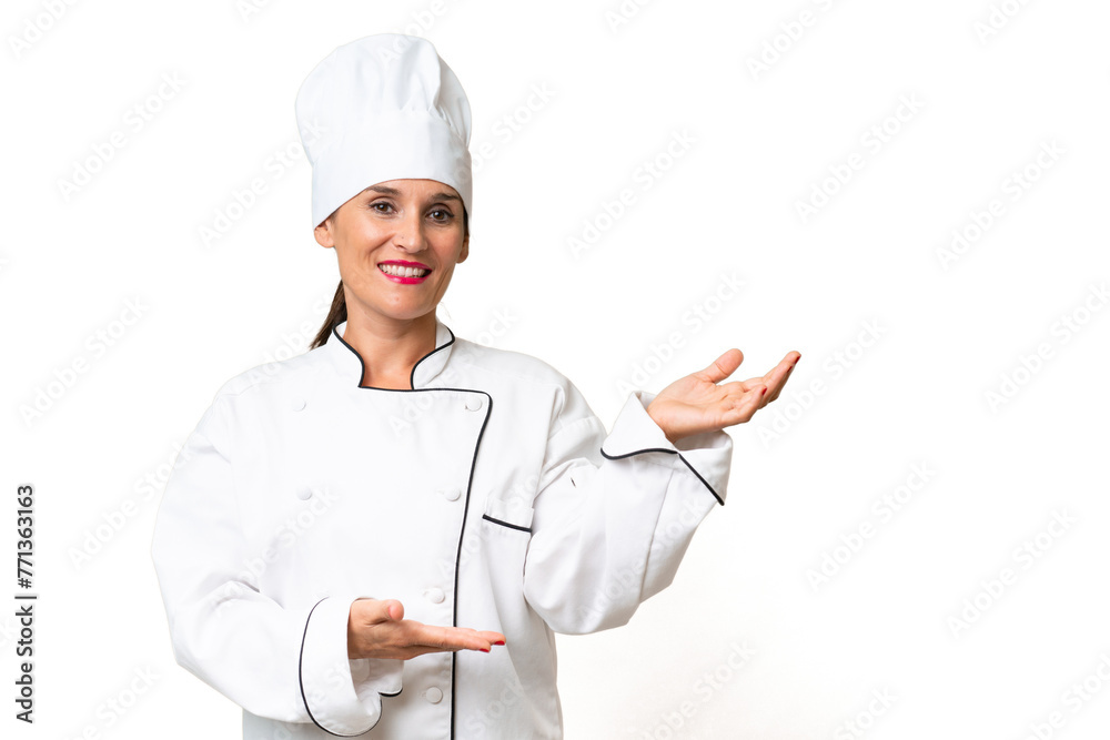 Middle-aged chef woman over isolated background extending hands to the side for inviting to come Middle-aged chef woman over isolated background extending hands to the side for inviting to come