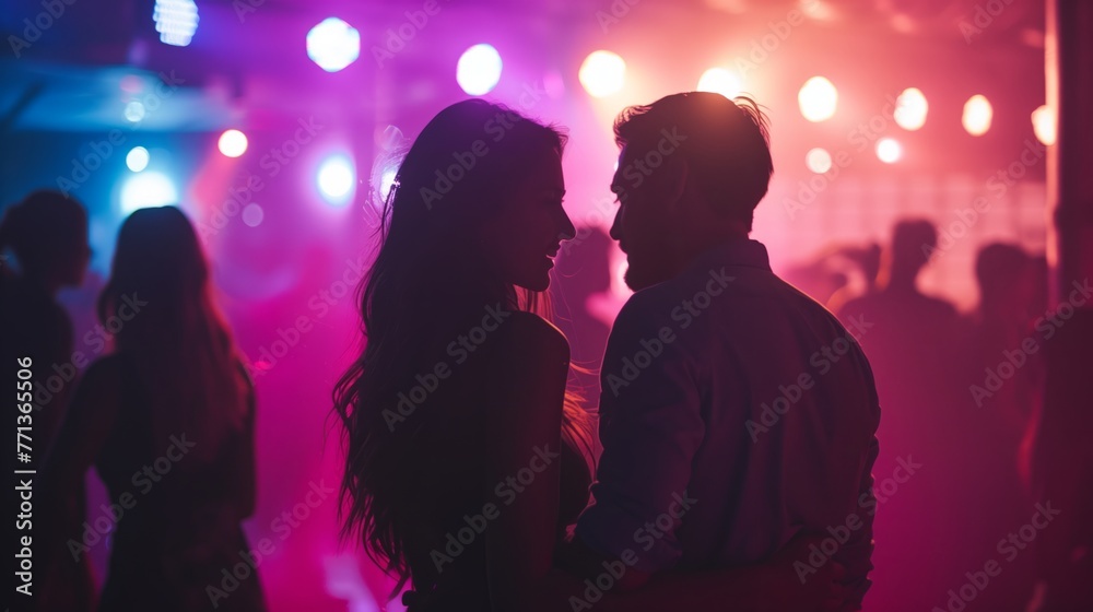 Stylish and beautiful young people dancing in nightclub, motion blur selective focus reportage photography style with flash. Sparkles and glimmers for glamour and excitement atmosphere.